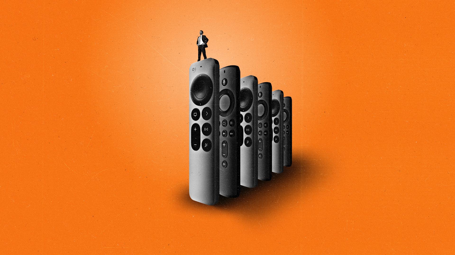 Man stands on a CTV remote with a row of CTV remotes behind him.