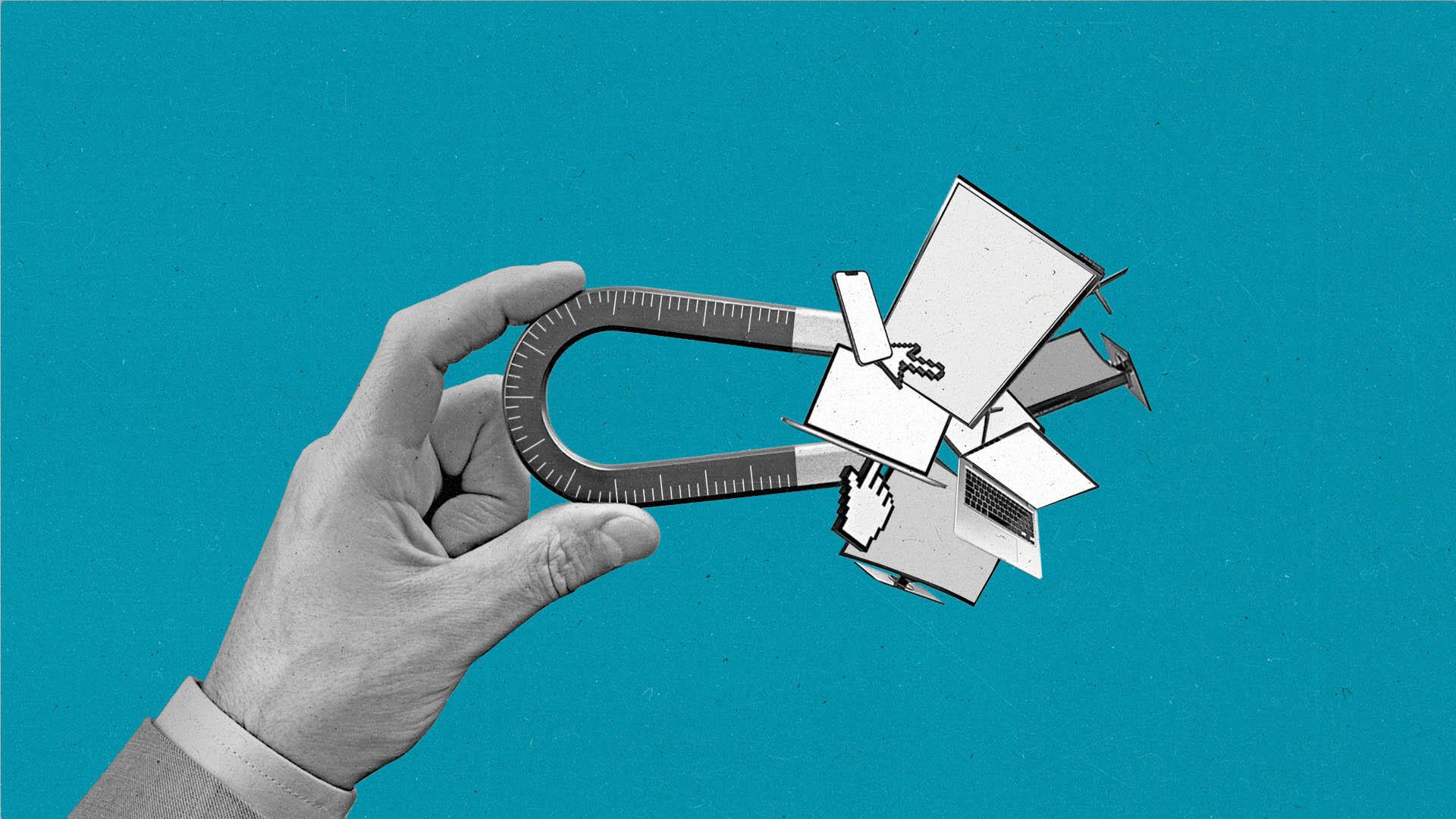 Giant hand holding a magnet that's attracting different devices.