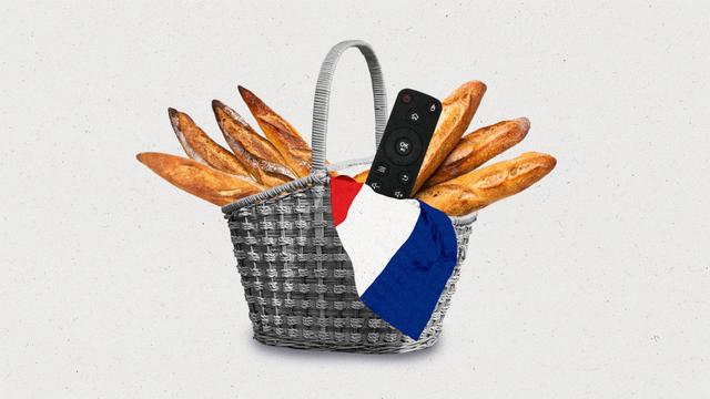 A black and white wicker basket holding baguettes, the French flag, and a streaming remote control.