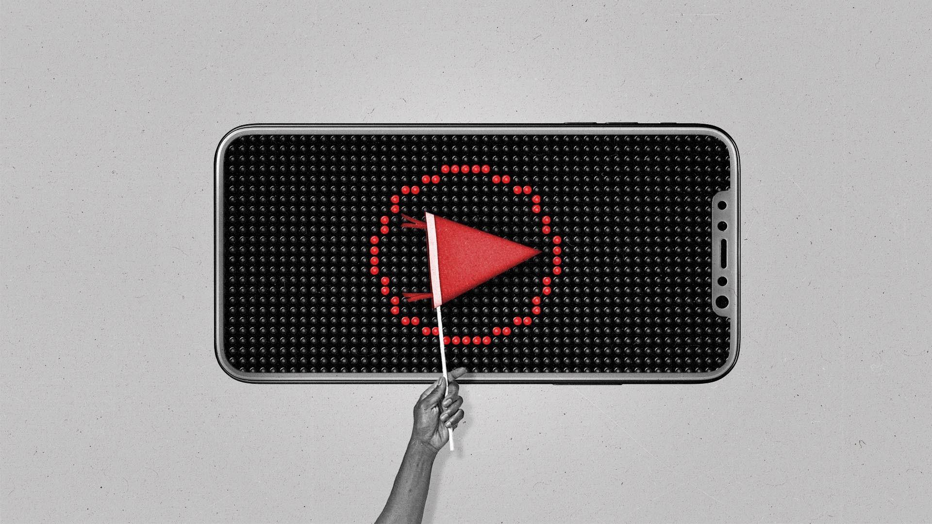 A hand holds up a pennant in front of a smartphone that displays a circle in a scoreboard style.