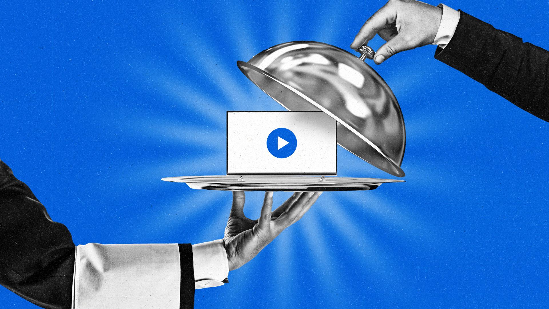 A waiter's hand holding a silver platter with a Smart TV on it.