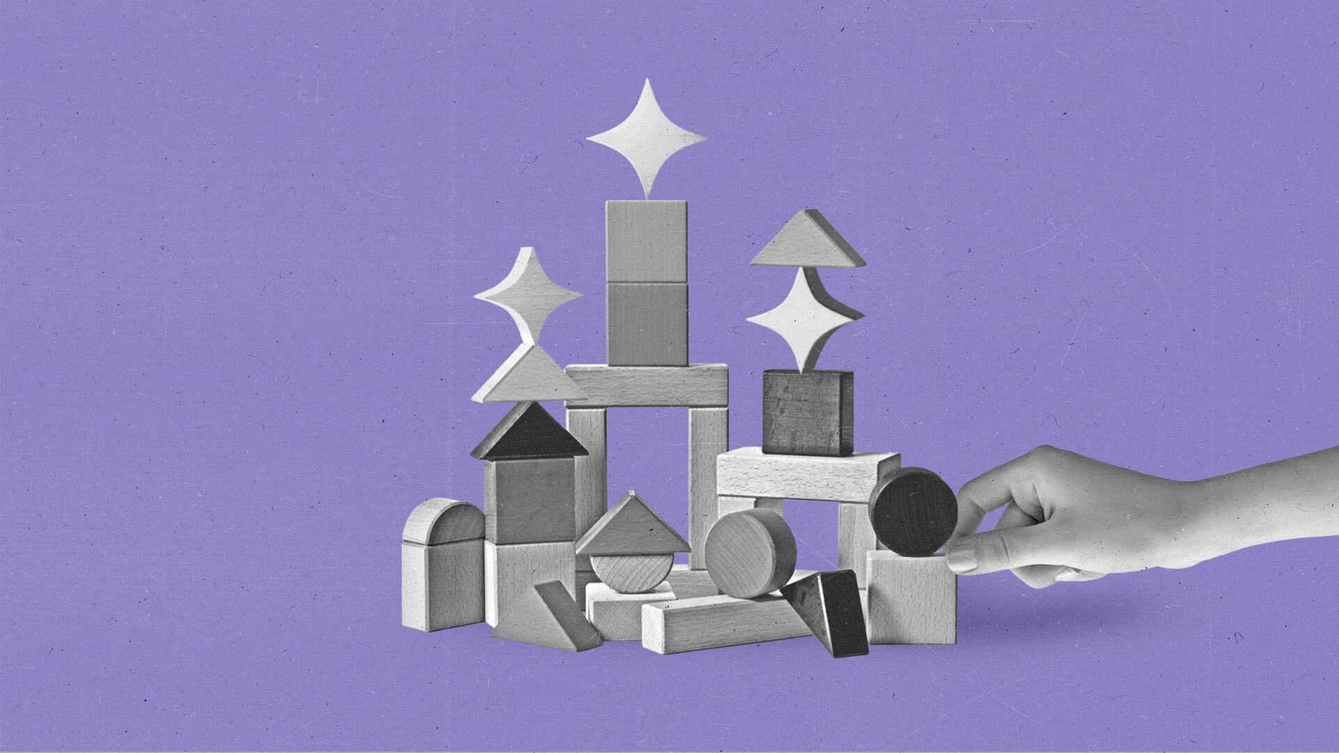 A hand stacks building blocks with sparkles.