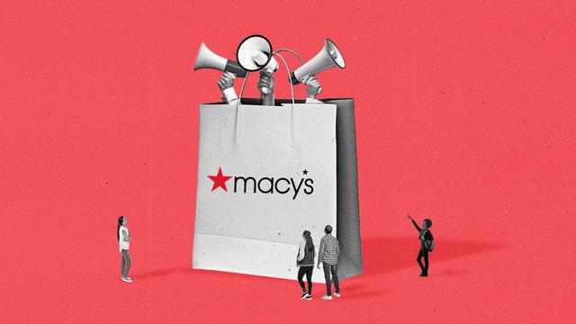 Three hands holding megaphones stick out of an oversized Macy's retail bag as people look on.