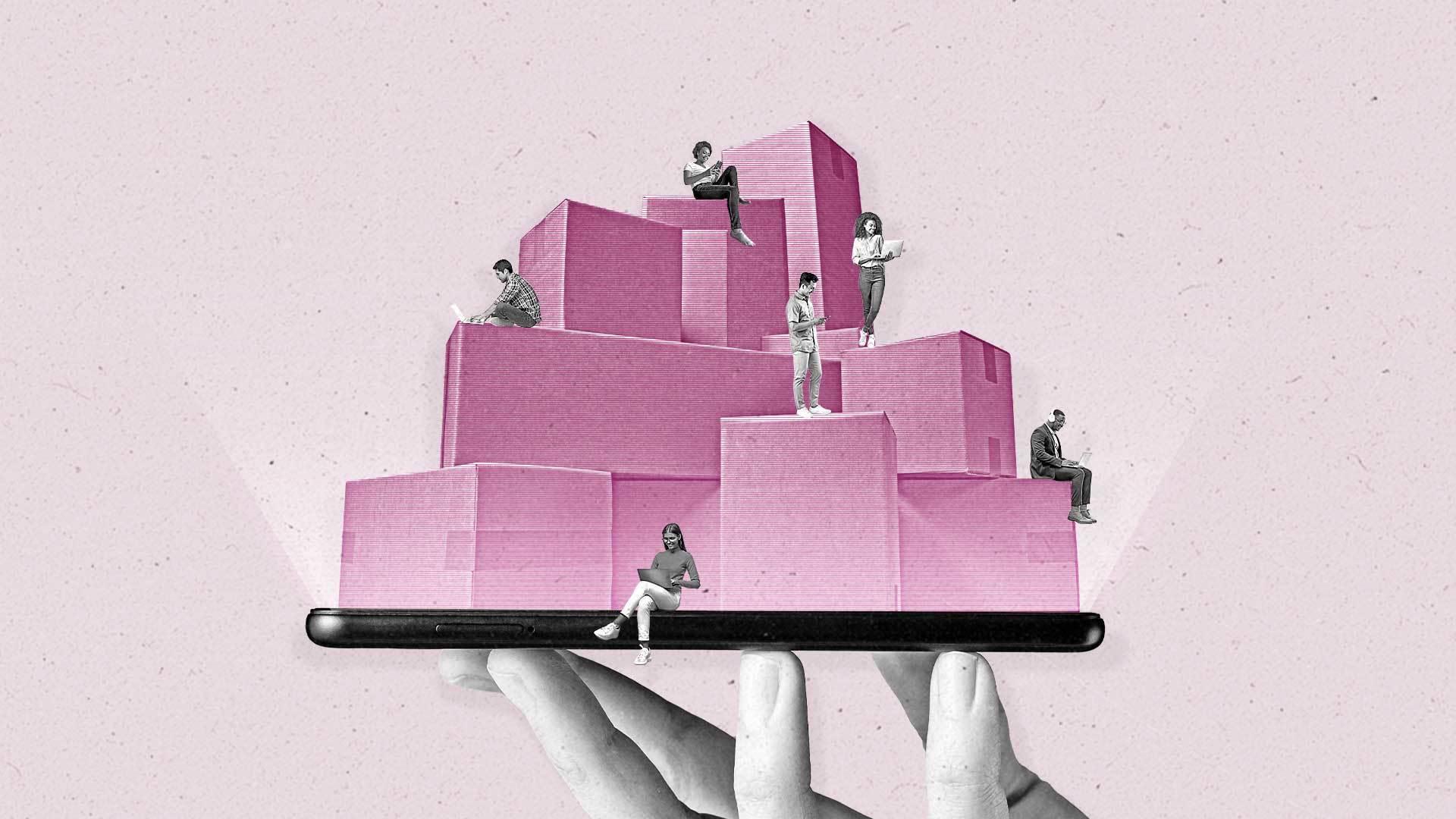 A hand holds a smartphone balancing stacks of boxes with millennials interacting with laptops and smartphones.