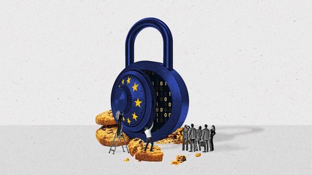 A opened lock with the European Union stars sits upon crushed cookies as a crowd looks on.