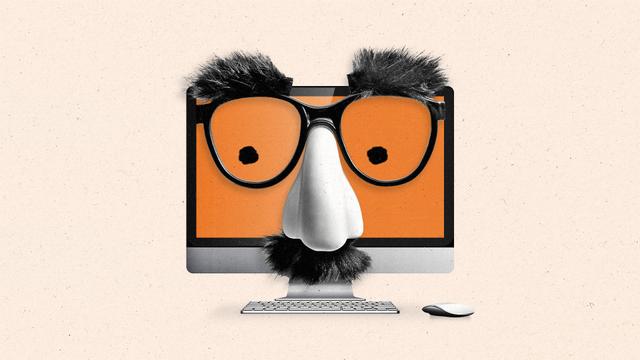A computer monitor is wearing a classic disguise mask with a fake nose, eyeglasses, and a mustache.