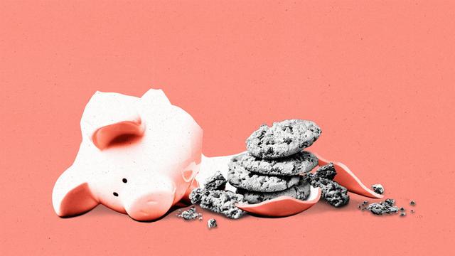 A cracked piggy bank with broken cookies spilling out.