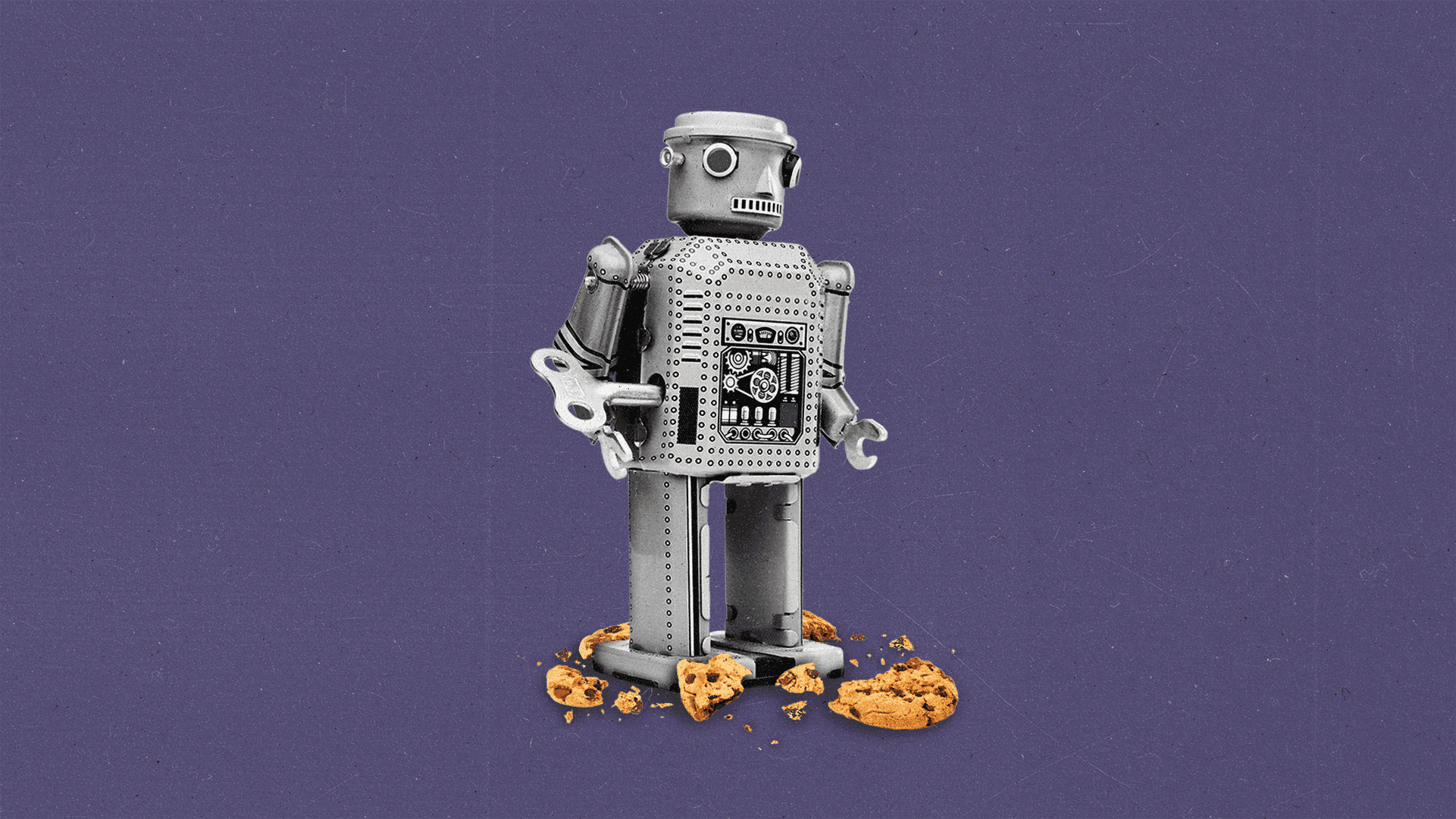 Tin toy robot standing on top of crushed chocolate chip cookie pieces