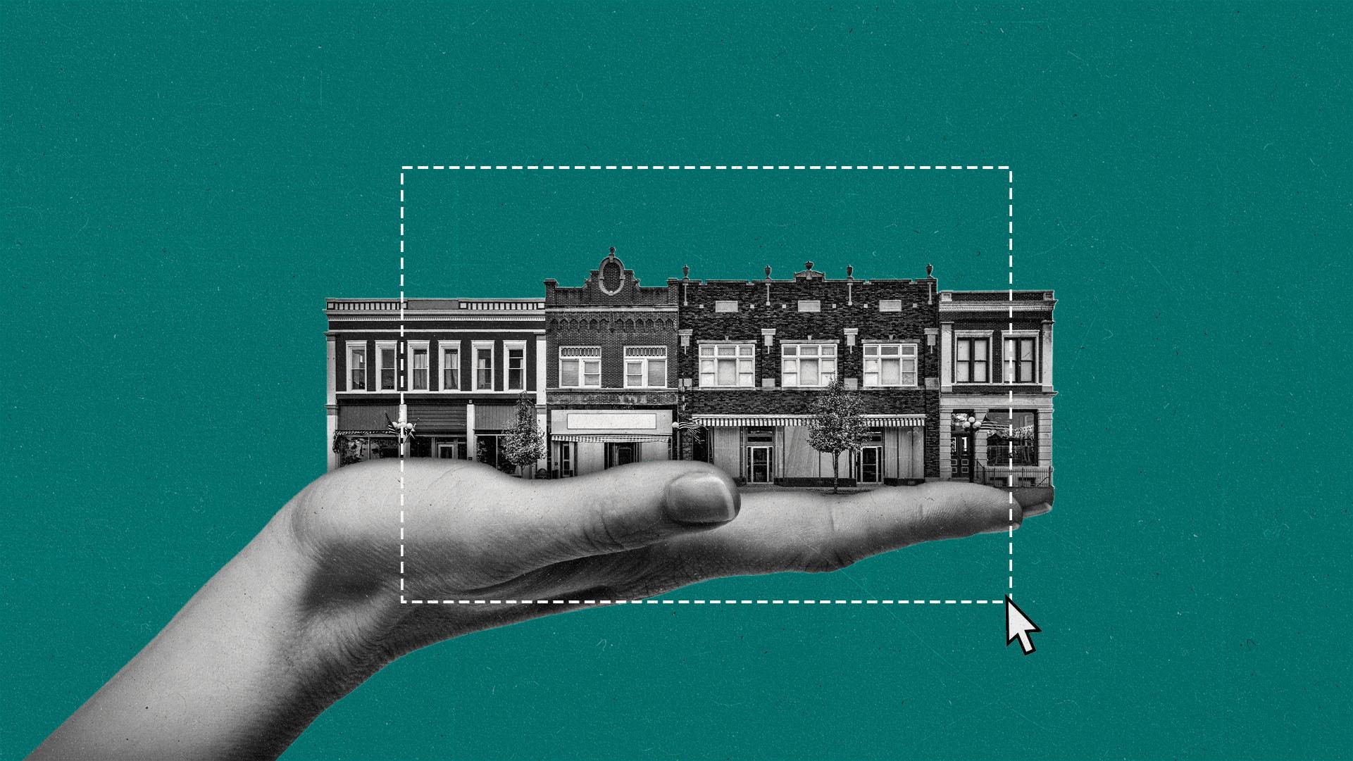 A large hand holding a small-town block inside it. A cursor drags a rectangular digital marquee around the town buildings.