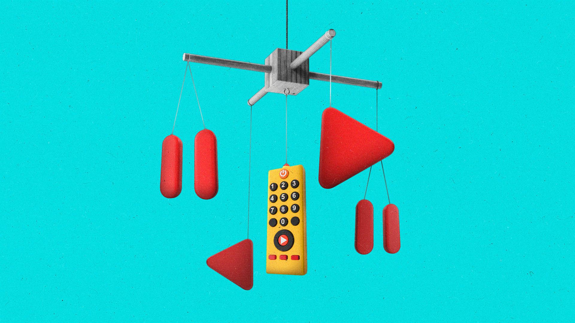 A child's mobile with colorful play and pause button and a remote hanging from it.