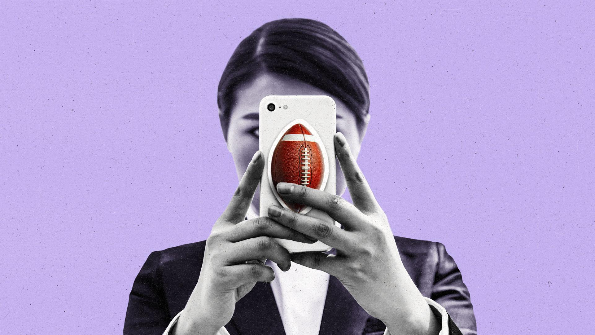 Person holding phone with a large football sticker on it in front of their face.