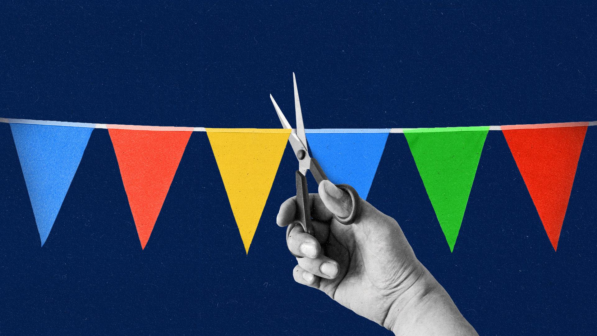 Triangle bunting in blue, red, green and yellow being cut by a greyscale hand with scissors.