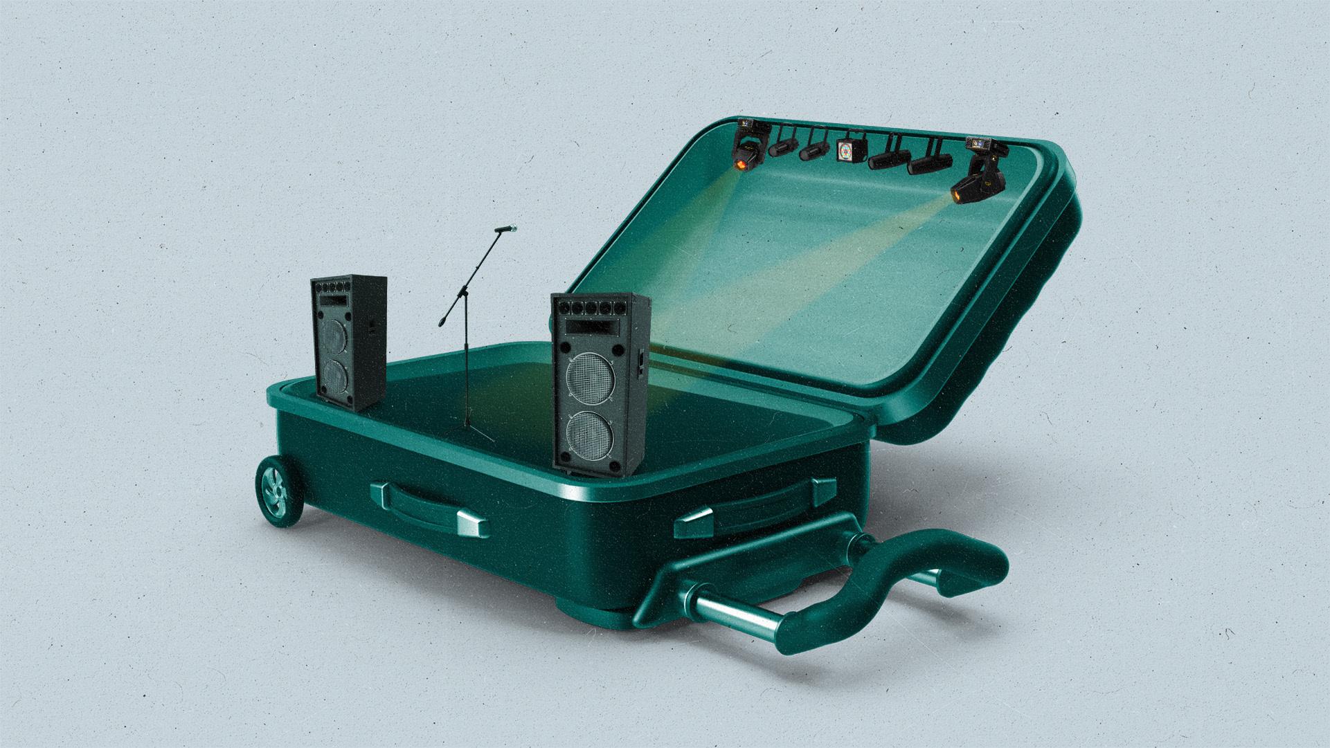 A green suitcase sits open with a stage inside with yellow spotlights.