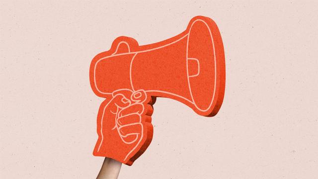 An arm with a foam finger made to look like a hand with a megaphone.