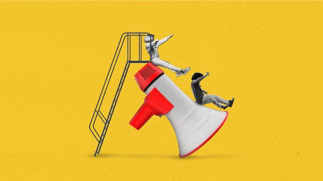 Teens sliding down a megaphone slide