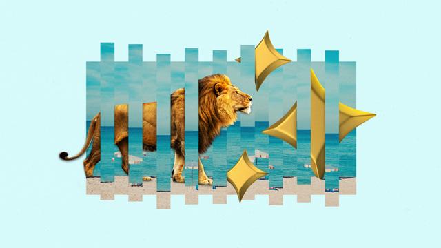 A lion walks through a beach with gold stars.