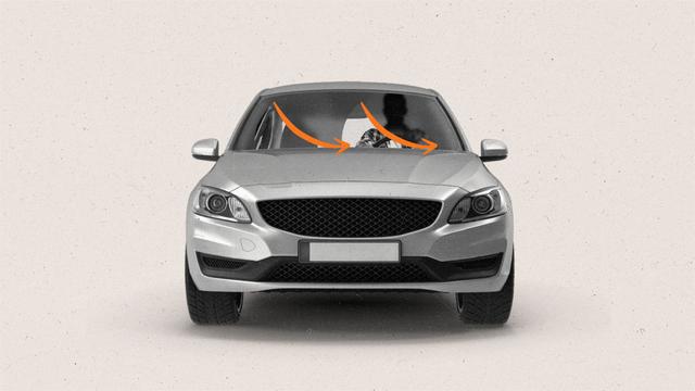 A forward facing car with fogged windshield being wiped by orange wipers in the shape of orange arrows.
