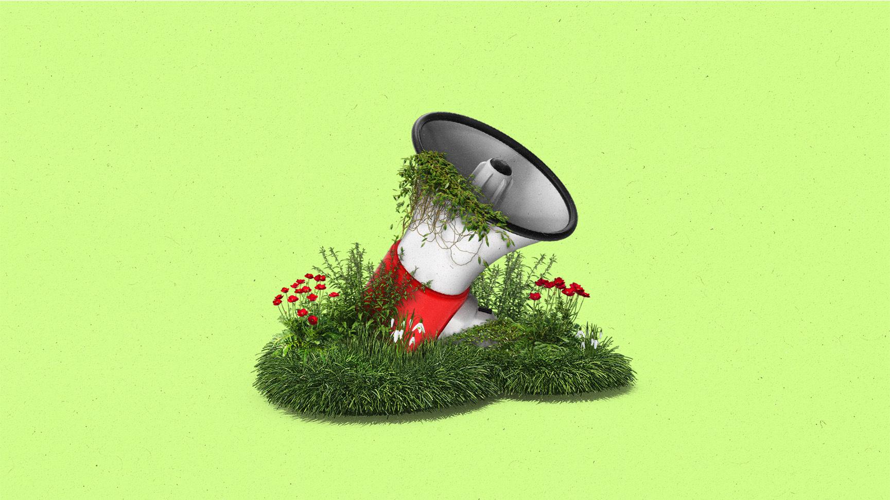 A megaphone overgrown with plants, flowers and ivy.