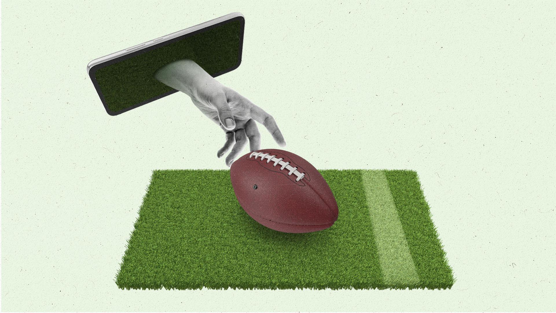 A hand reaches out of a smartphone towards an American football.