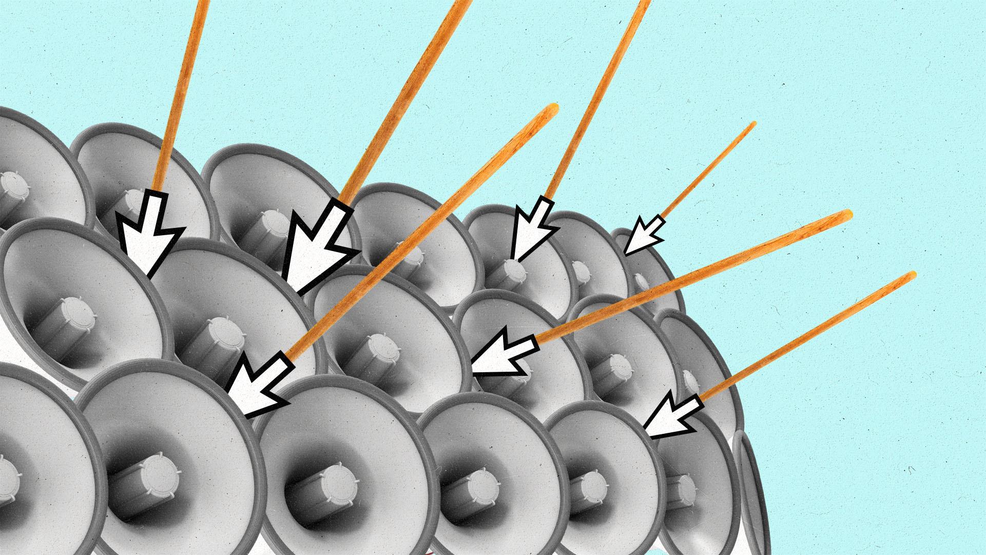 megaphones stacked on top of each other to mimic a shield wall, with cursor-tipped spears stuck in them.