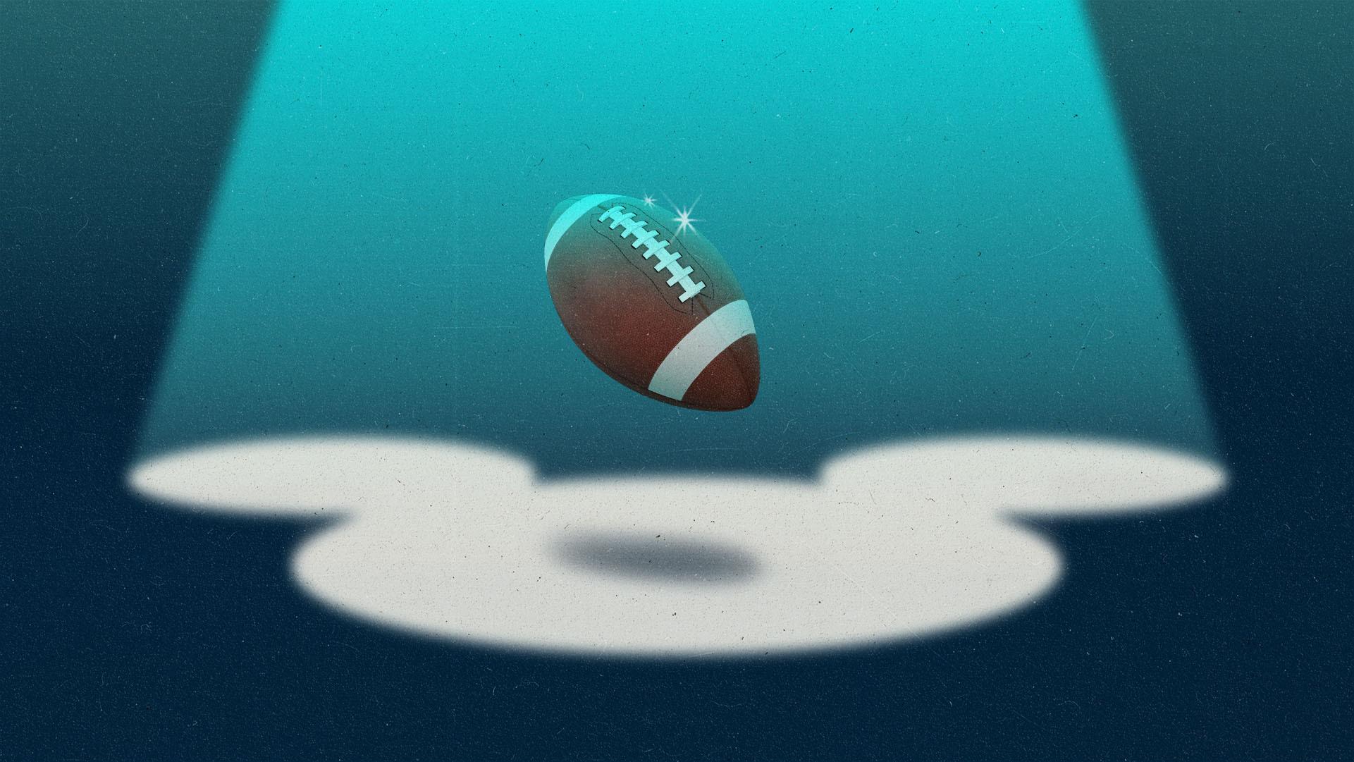 A floating football in a Mickey-shaped spotlight.