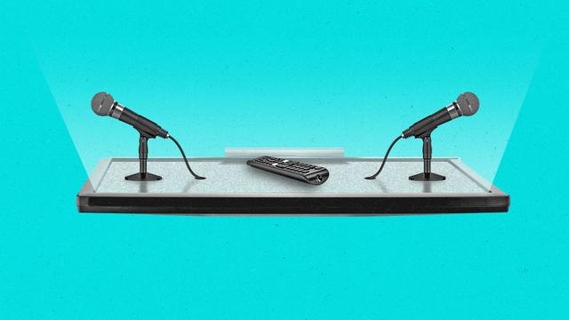 A streaming remote and two microphones sit on top of a connected TV as if it were a table.