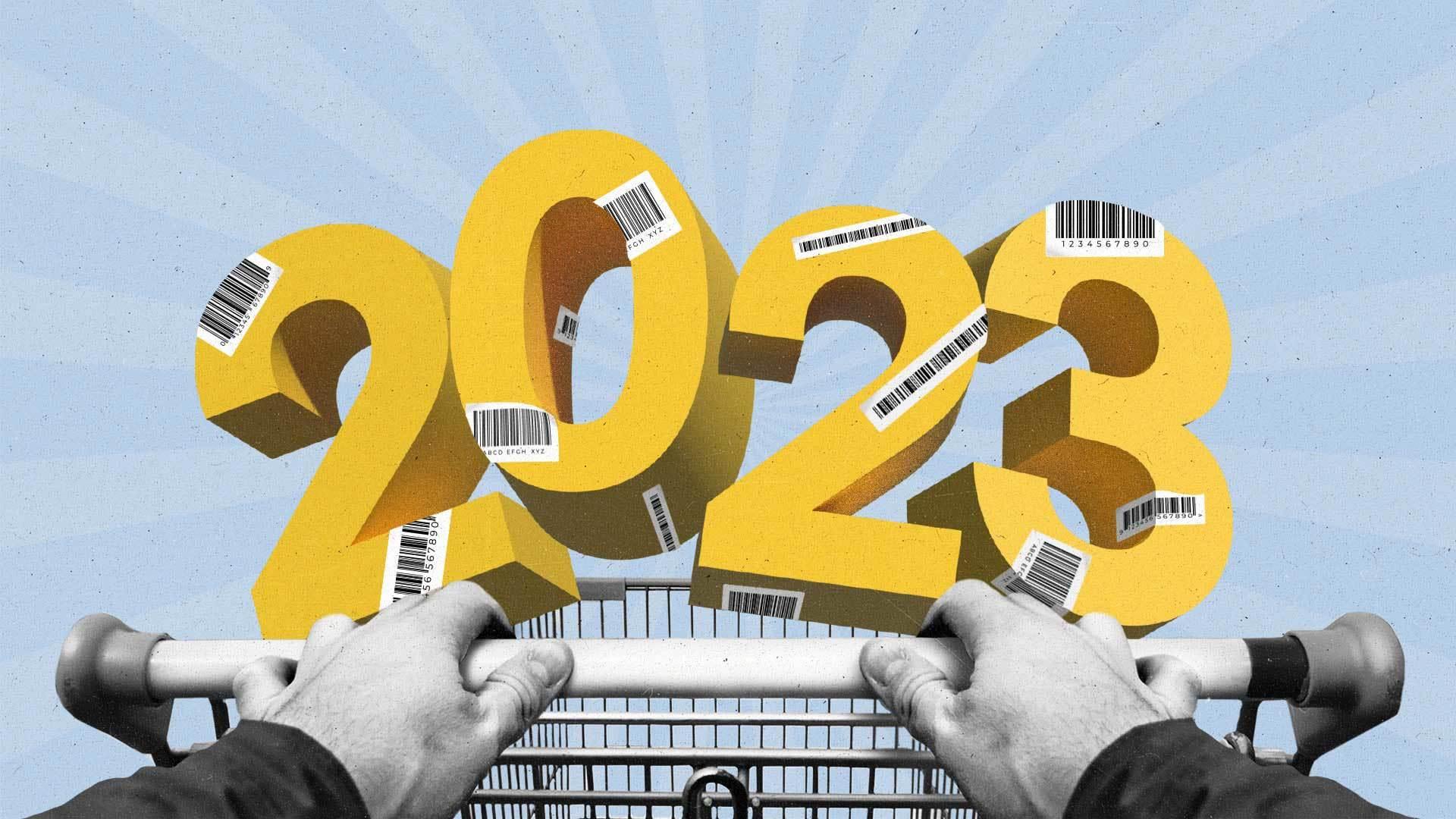 A man rolls a shopping cart with the number 2023 balanced along the top. The numbers are covered in barcodes.