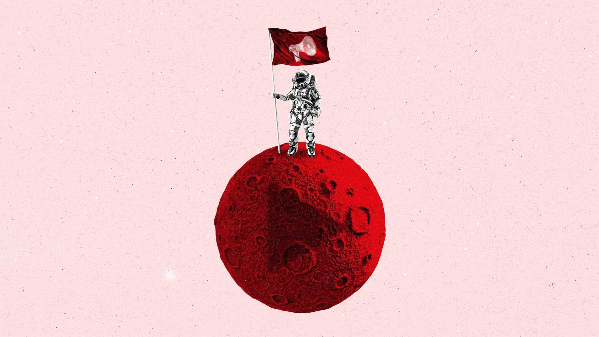 An astronaut holding a flag with a megaphone on it stands on a small, red planet.